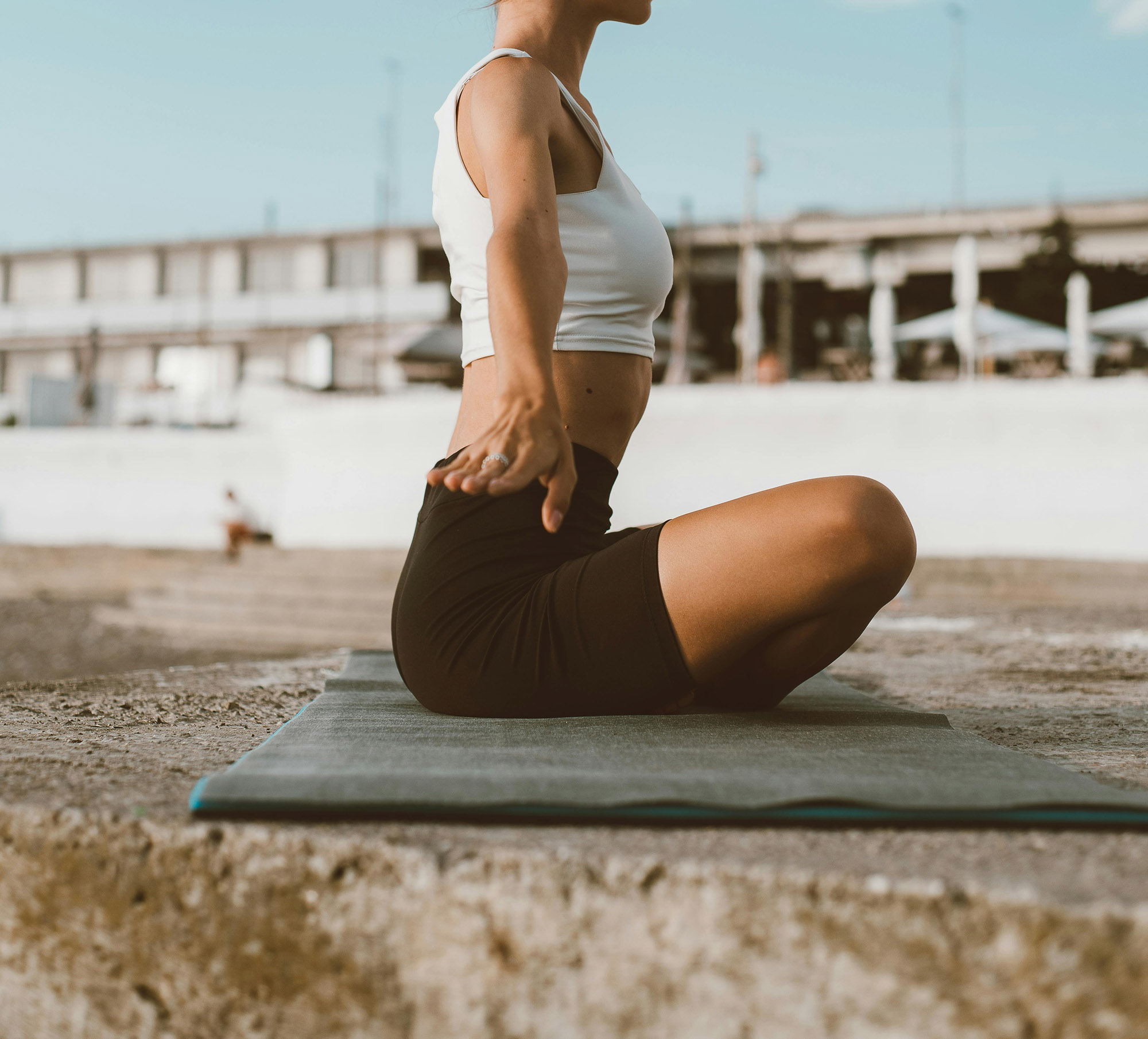 Woman doing yoga on the beach
