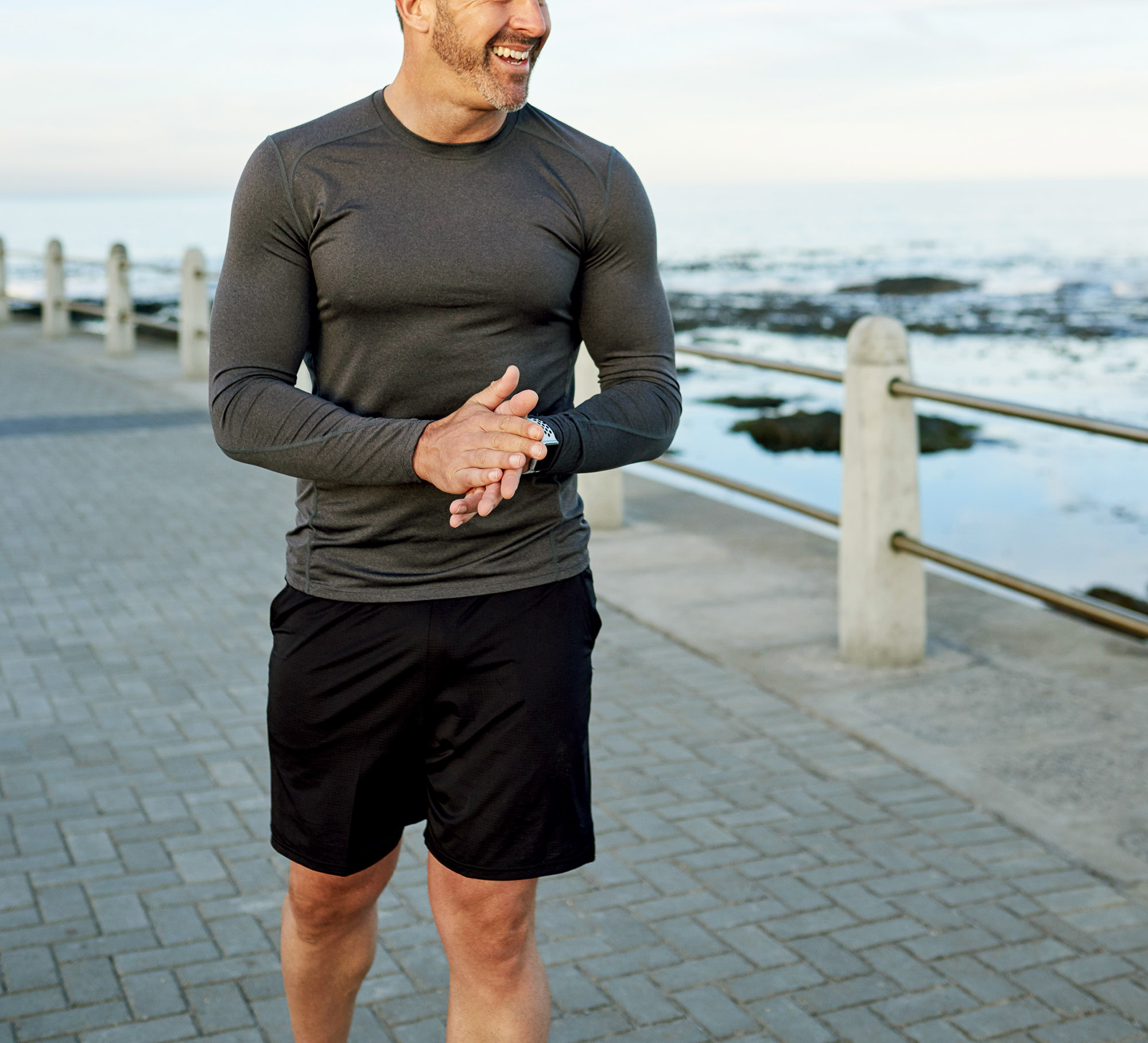 Middle aged man walking by waterfront