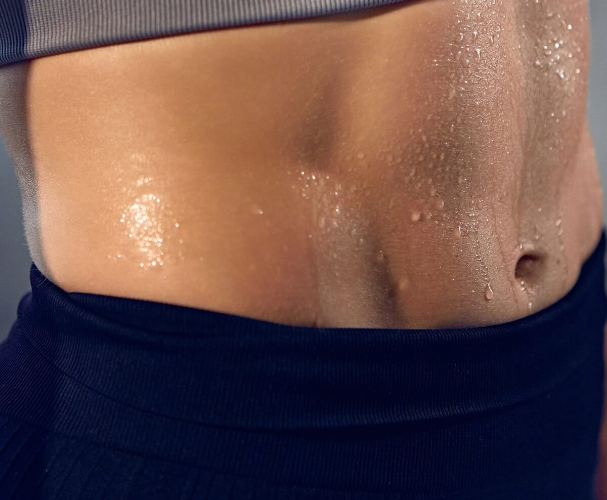 Close up of woman's sweating stomach