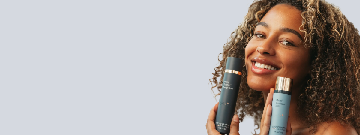 woman holding skincare products