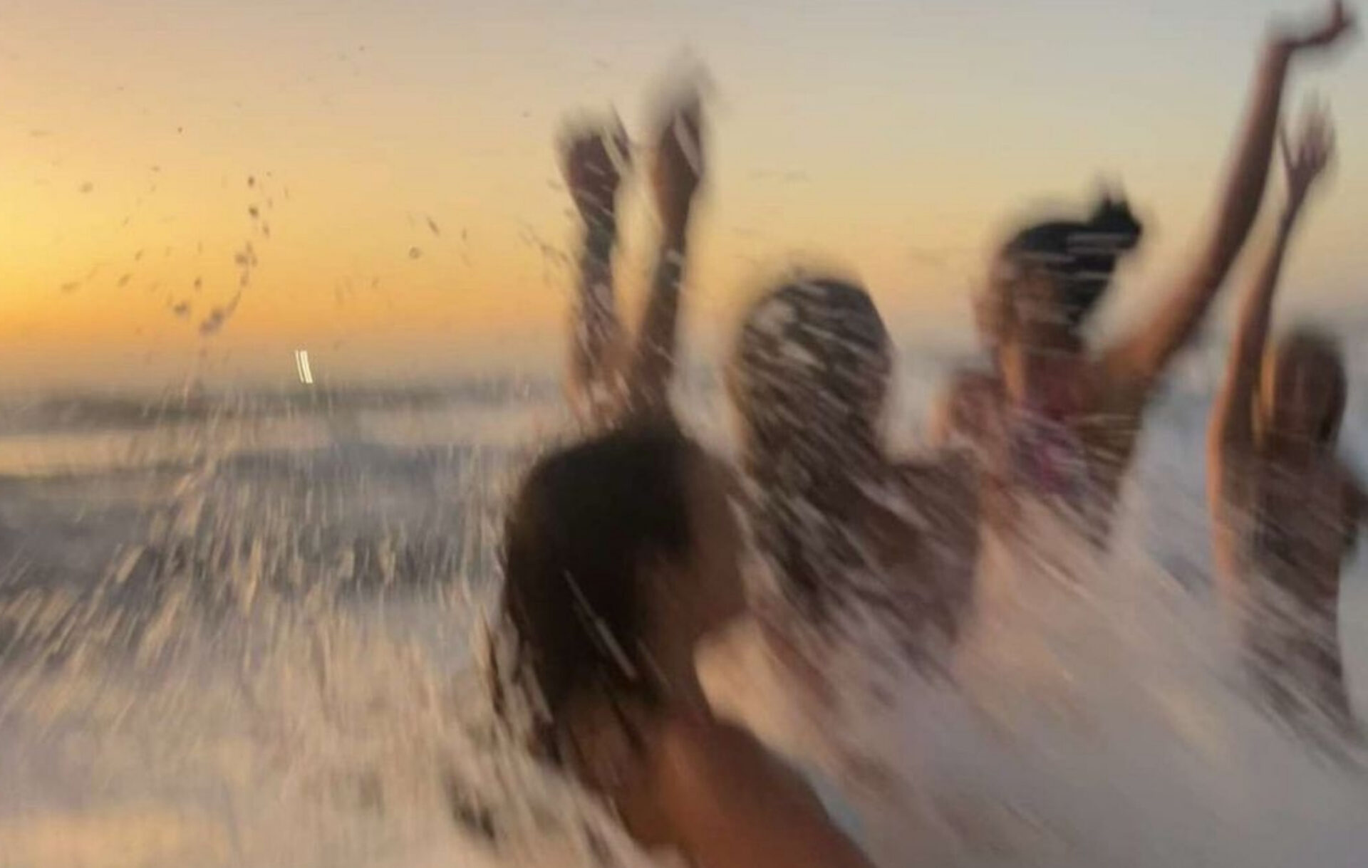 Group of women splashing in the ocean